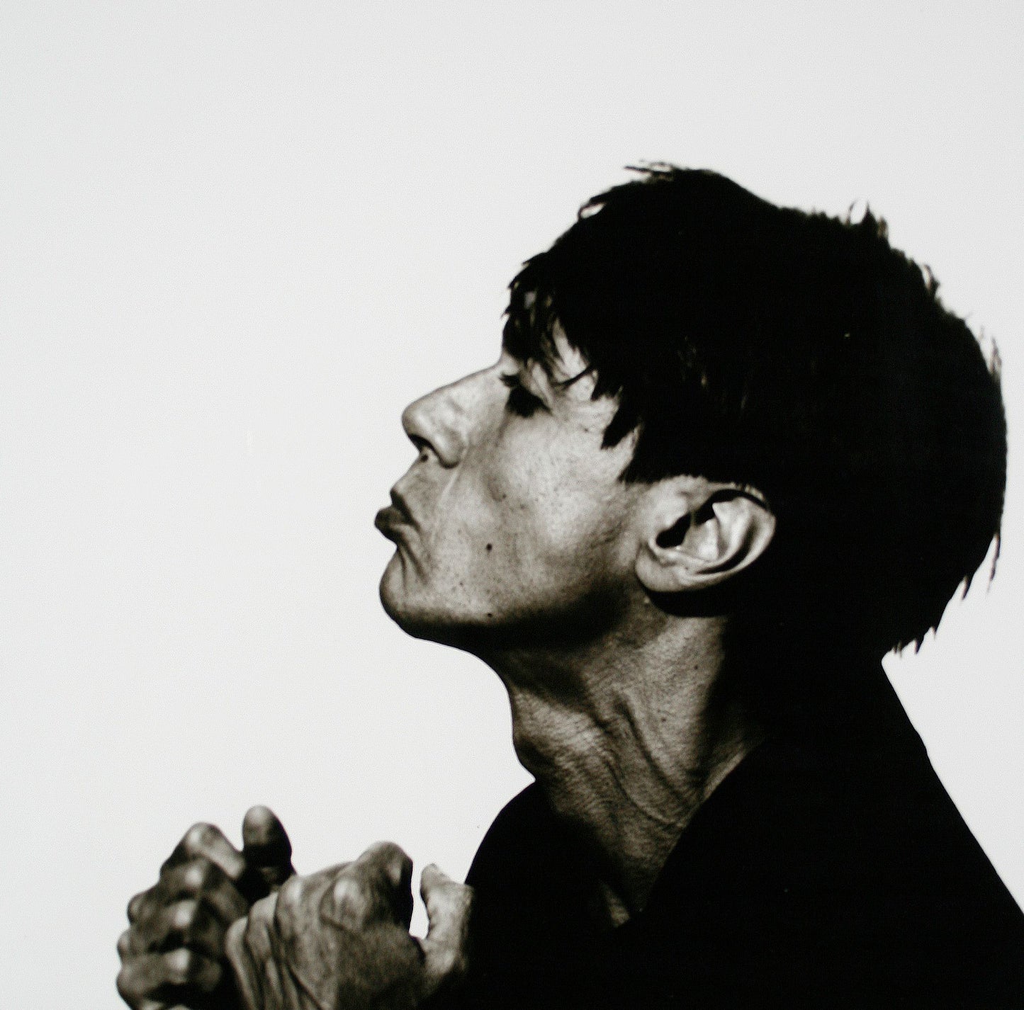 Black and white silver gelatin darkroom portrait of Iggy Pop during the 1986 SOUNDS cover session in Mayfair by Peter Anderson.