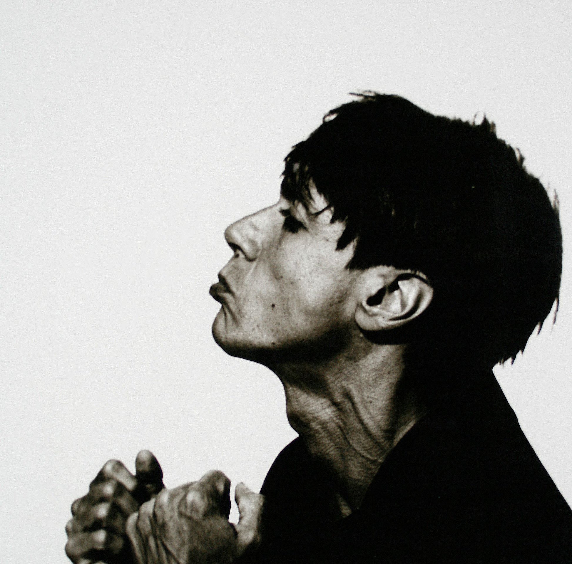 Black and white silver gelatin darkroom portrait of Iggy Pop during the 1986 SOUNDS cover session in Mayfair by Peter Anderson.