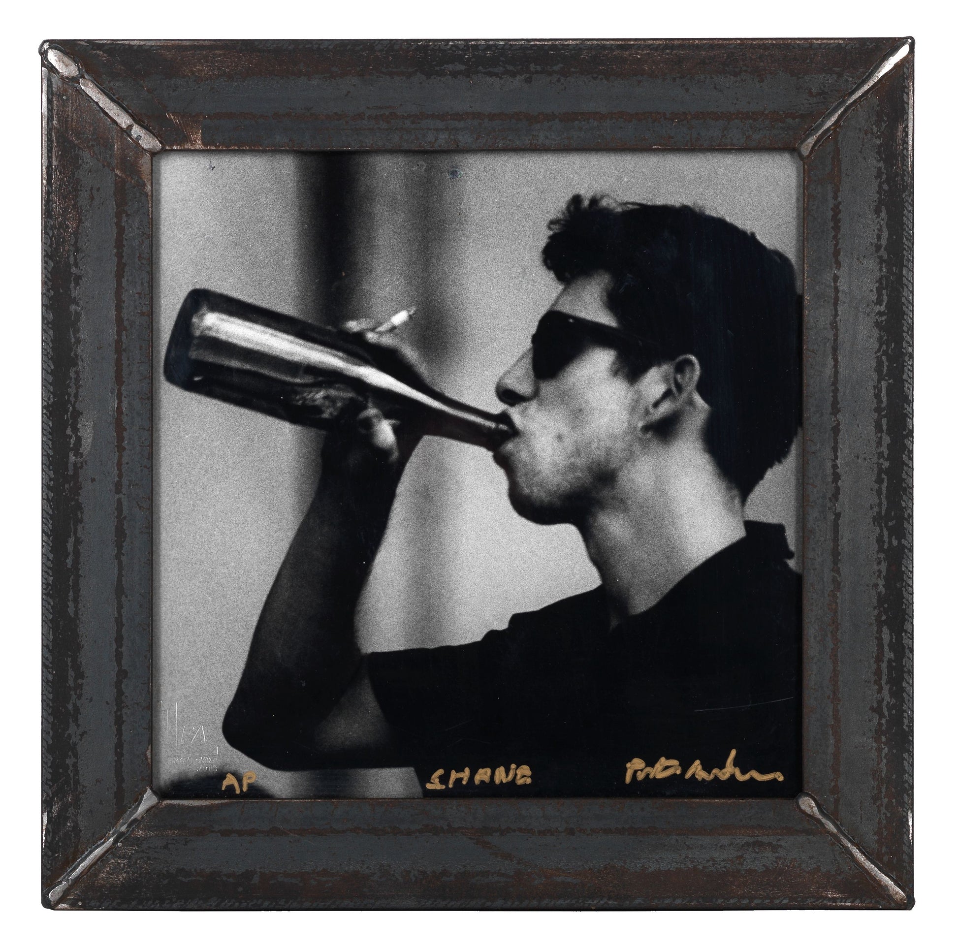 Square black and white silver gelatin darkroom performance print of Shane MacGowan at Cambridge Folk Festival 1985 in a custom welded steel frame by Peter Anderson.